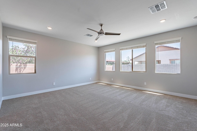empty room featuring plenty of natural light, baseboards, a ceiling fan, carpet flooring, and recessed lighting