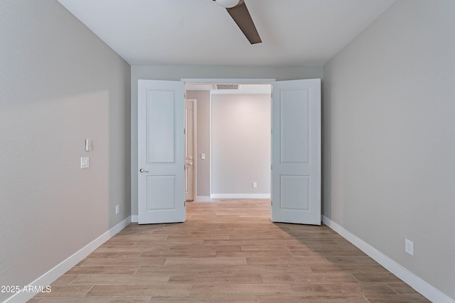 unfurnished bedroom with light wood-style floors, baseboards, and a ceiling fan