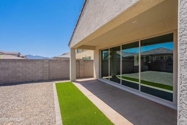 view of yard featuring fence and a patio area