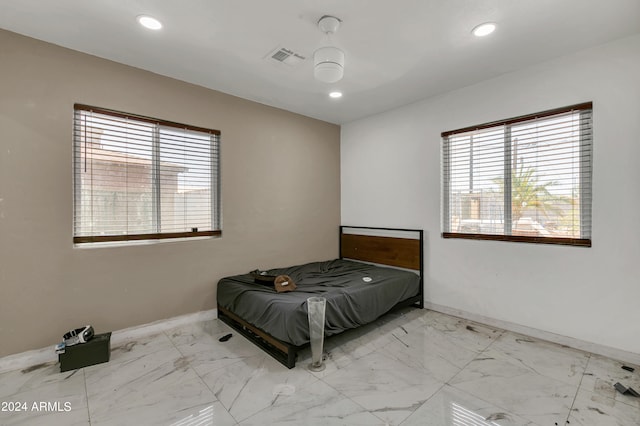 unfurnished bedroom featuring light tile patterned floors and ceiling fan