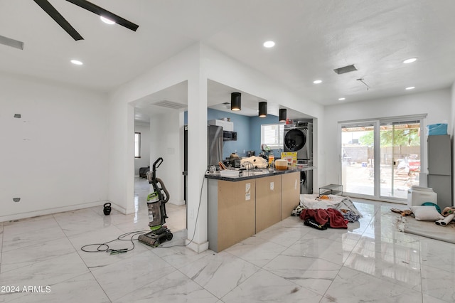 kitchen with a healthy amount of sunlight and stacked washing maching and dryer