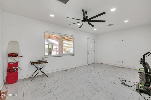 interior space with light tile patterned floors and ceiling fan