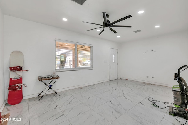 interior space with ceiling fan