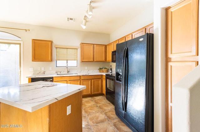 kitchen with sink, black appliances, and track lighting