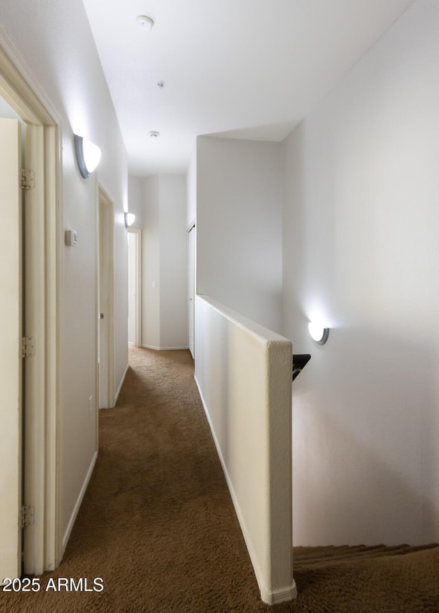 hallway featuring dark carpet