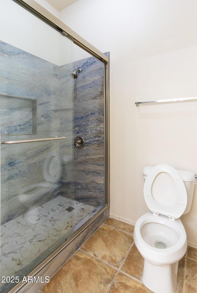 bathroom featuring toilet and walk in shower