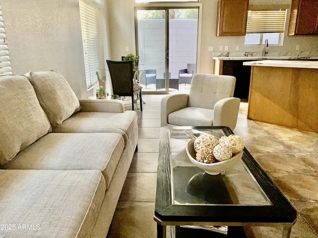 living room featuring sink and plenty of natural light