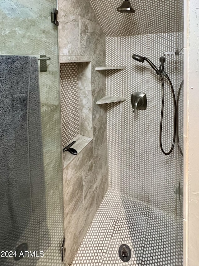 bathroom with a tile shower