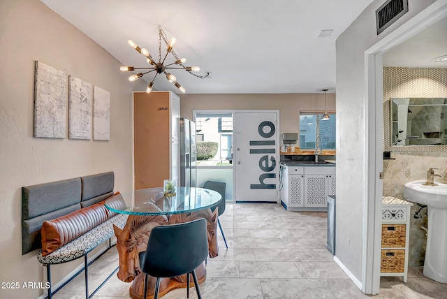 dining room featuring visible vents and an inviting chandelier