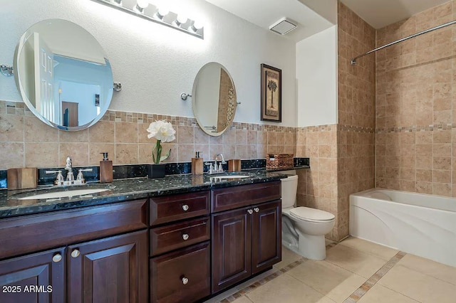 5335 E Shea Blvd Unit 2081, Scottsdale, AZ 85254 - full bathroom featuring double vanity, shower / washtub combination, toilet, tile patterned floors, and tile walls
