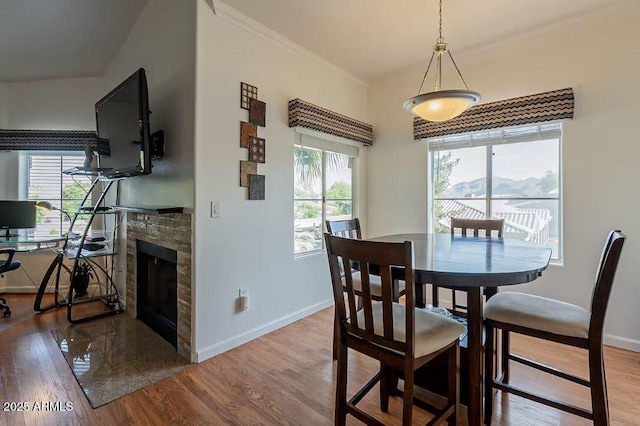5335 E Shea Blvd Unit 2081, Scottsdale, AZ 85254 - dining room featuring healthy amount of natural light, wood finished floors, baseboards, and a fireplace
