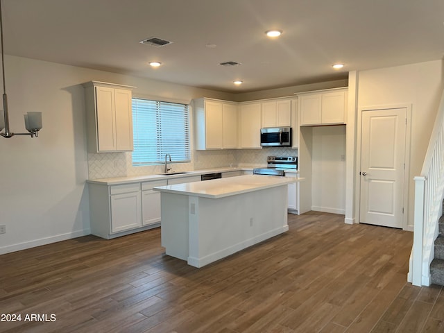 kitchen with a kitchen island, white cabinets, stainless steel appliances, and dark hardwood / wood-style floors