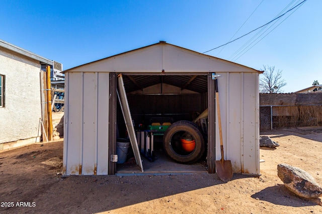 view of shed with fence