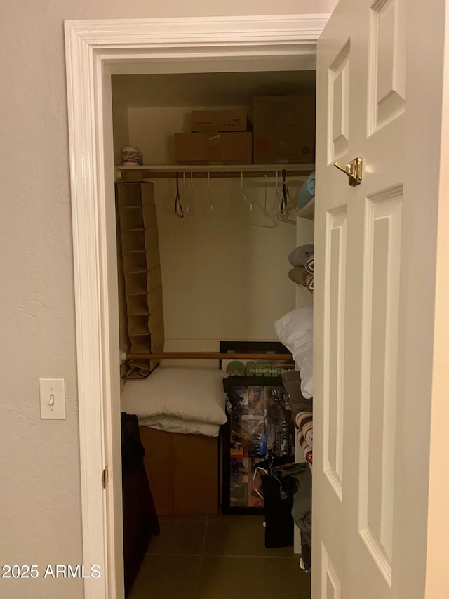 walk in closet featuring dark tile patterned floors