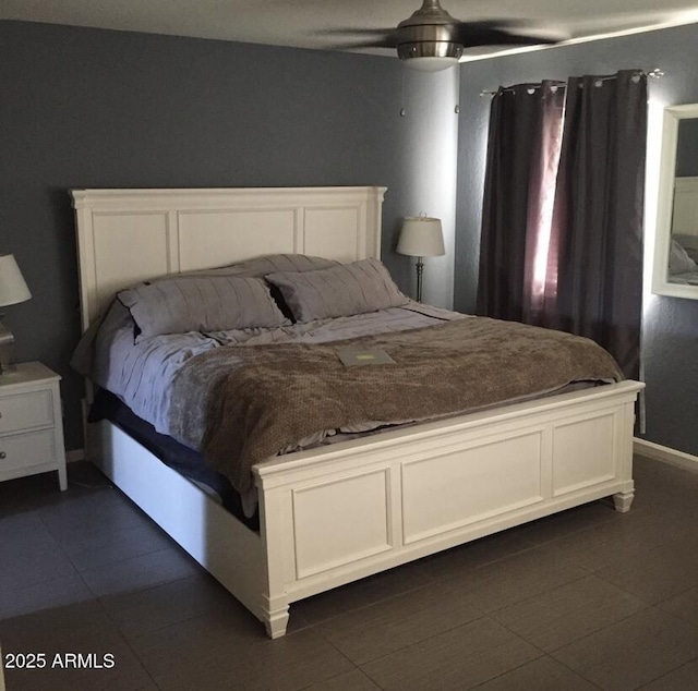 bedroom featuring dark tile patterned floors and ceiling fan