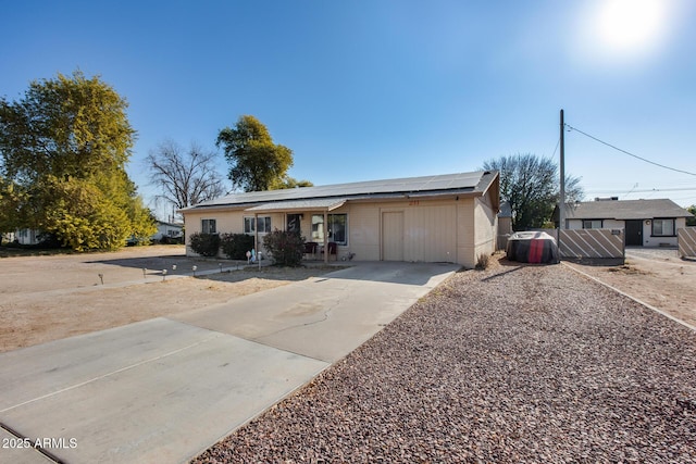 ranch-style home featuring solar panels