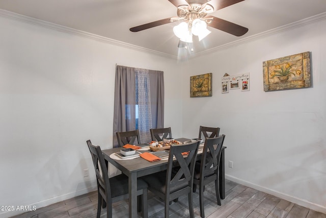 dining room with crown molding, ceiling fan, and wood-type flooring