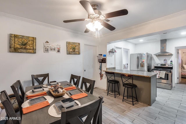 dining space with ceiling fan, ornamental molding, and light hardwood / wood-style floors