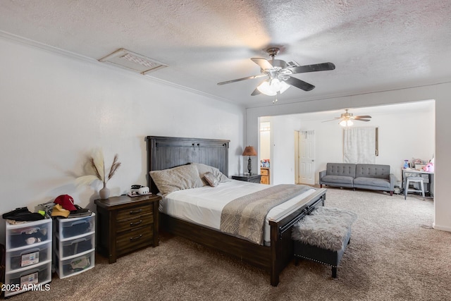 carpeted bedroom featuring ceiling fan, crown molding, and a textured ceiling