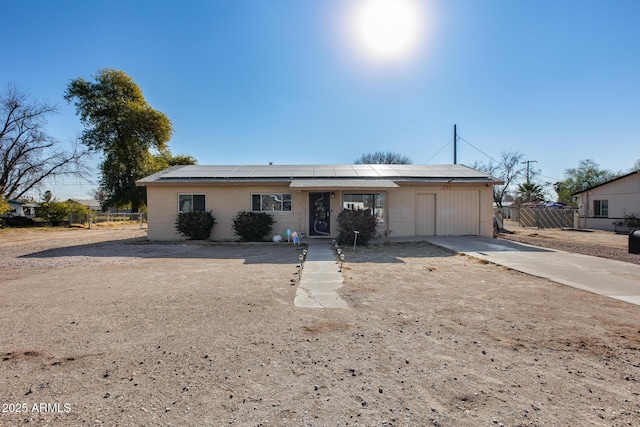 single story home featuring solar panels