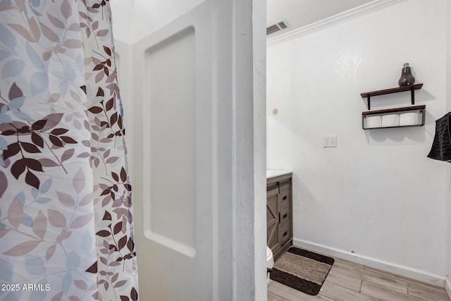 bathroom with hardwood / wood-style flooring, vanity, and a shower