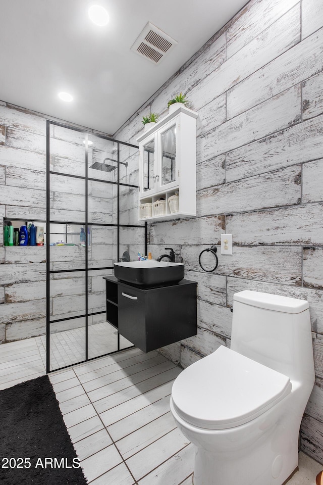 bathroom featuring walk in shower, vanity, and toilet