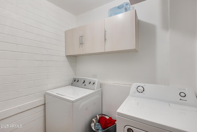 laundry area with cabinets and washer and clothes dryer