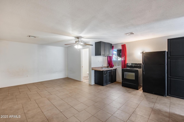 kitchen featuring light tile patterned flooring, sink, a textured ceiling, ceiling fan, and black appliances