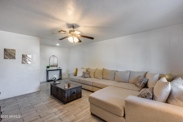 living room with ceiling fan and light hardwood / wood-style flooring