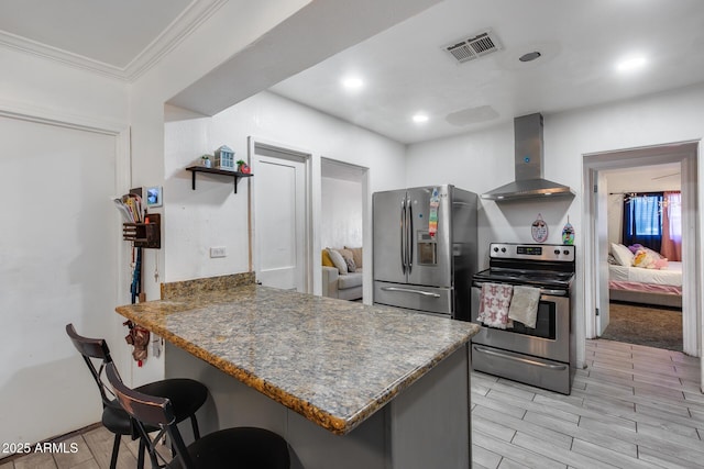 kitchen with a kitchen breakfast bar, stainless steel appliances, ornamental molding, kitchen peninsula, and wall chimney exhaust hood