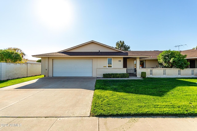 single story home with a garage and a front lawn