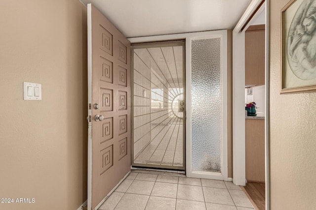 doorway with light tile patterned floors