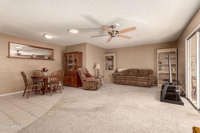 tiled living room featuring a textured ceiling and ceiling fan