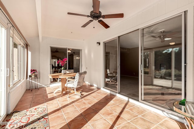 sunroom / solarium with beam ceiling and ceiling fan