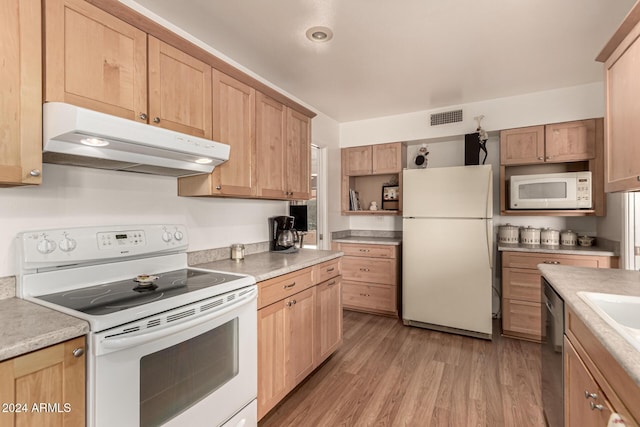 kitchen with light wood-type flooring and white appliances