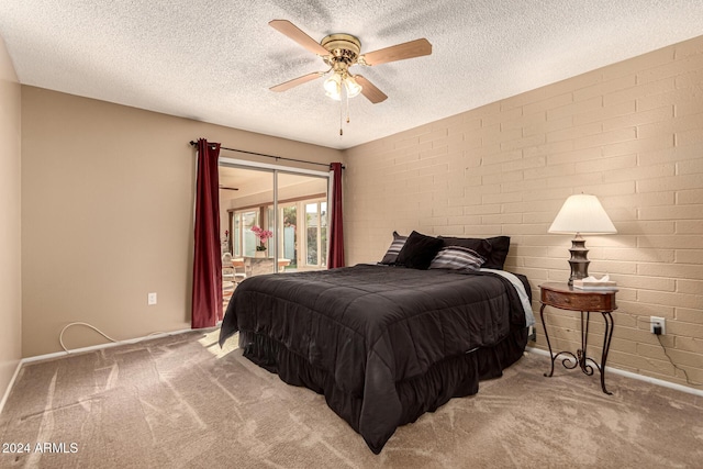 carpeted bedroom featuring a textured ceiling and ceiling fan