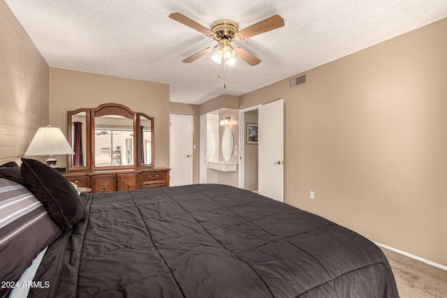 carpeted bedroom with ceiling fan and a textured ceiling