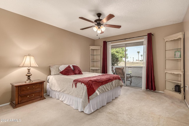 bedroom featuring access to exterior, light carpet, a textured ceiling, and ceiling fan