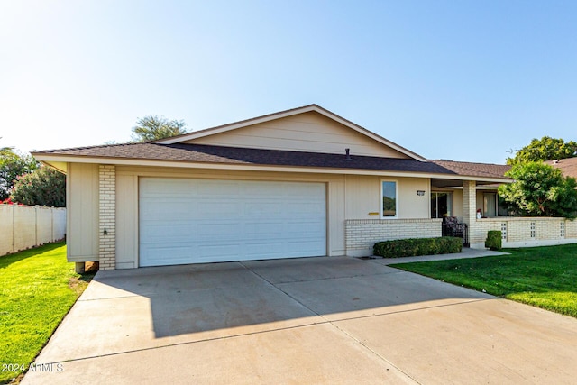 ranch-style home featuring a garage and a front yard