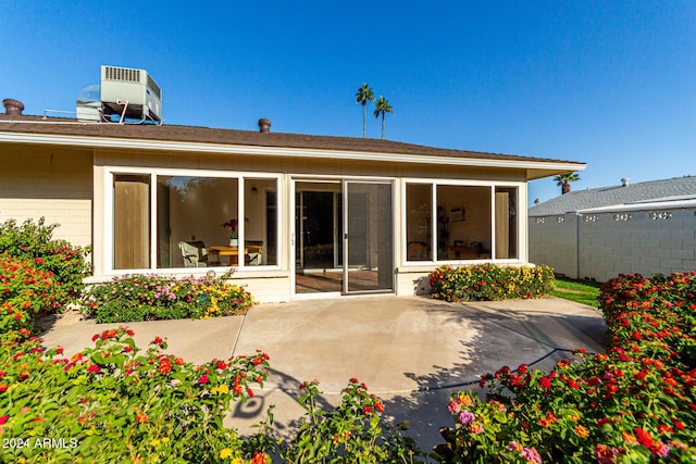 rear view of property with a patio and central AC unit