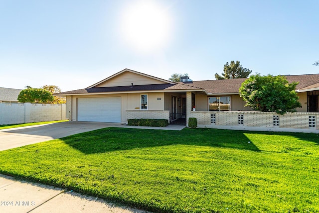 ranch-style home with a garage and a front lawn