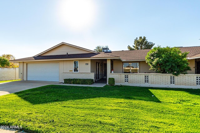 single story home featuring a garage and a front yard