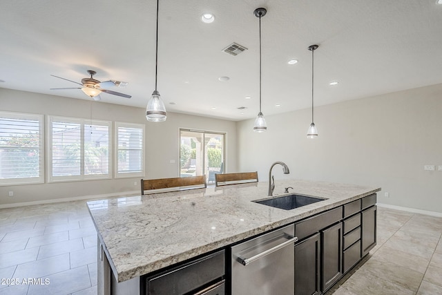 kitchen with a sink, stainless steel dishwasher, baseboards, ceiling fan, and recessed lighting