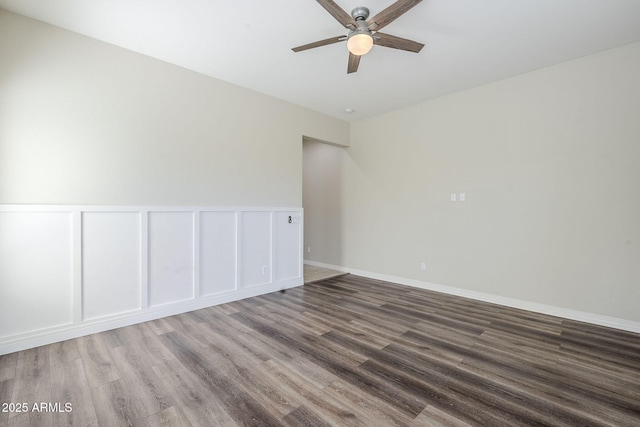 spare room featuring ceiling fan and wood finished floors