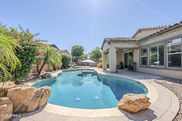 view of pool with a fenced backyard and a patio