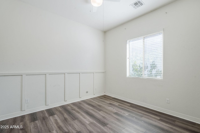 empty room featuring wood finished floors, ceiling fan, and baseboards