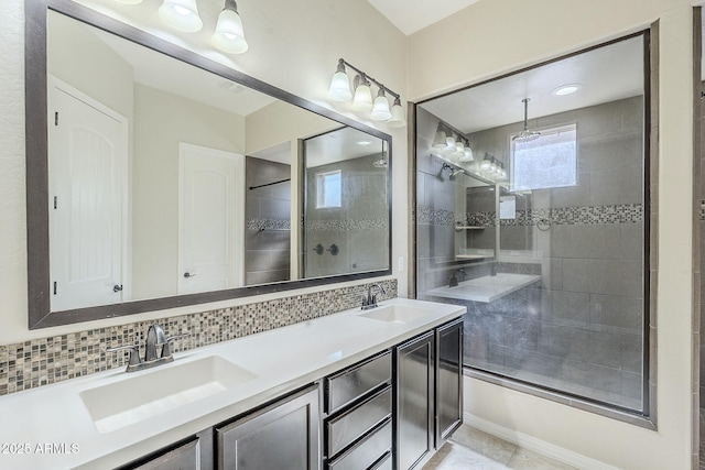 bathroom featuring decorative backsplash, double vanity, and a tile shower