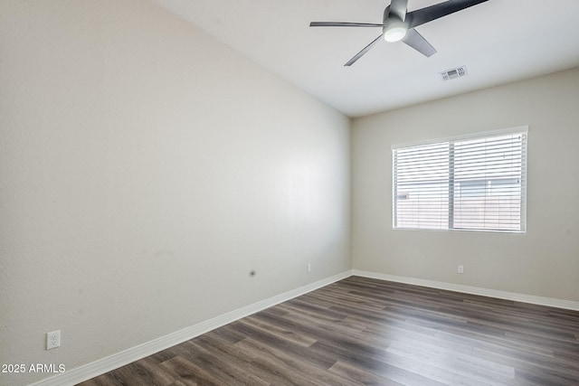 empty room featuring dark wood-type flooring, ceiling fan, and baseboards