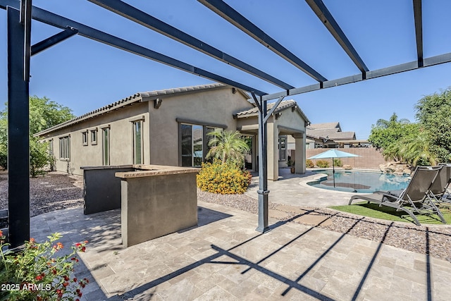 view of patio / terrace with an outdoor pool and fence