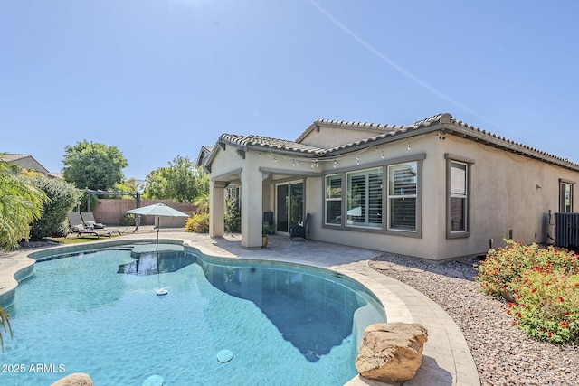 back of house with a fenced backyard, a patio area, central AC unit, stucco siding, and a tiled roof
